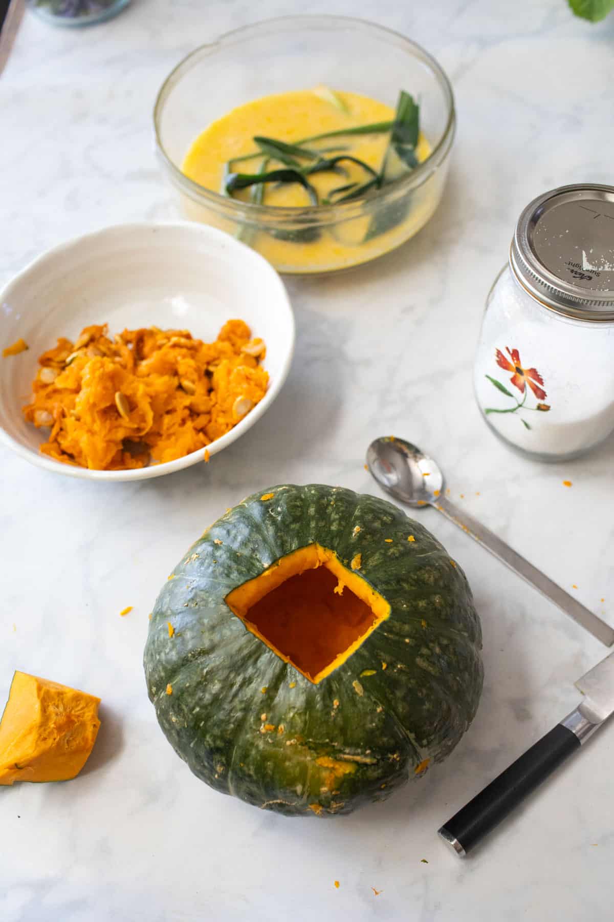 Carved and hollowed top of a kabocha squash on the table. 