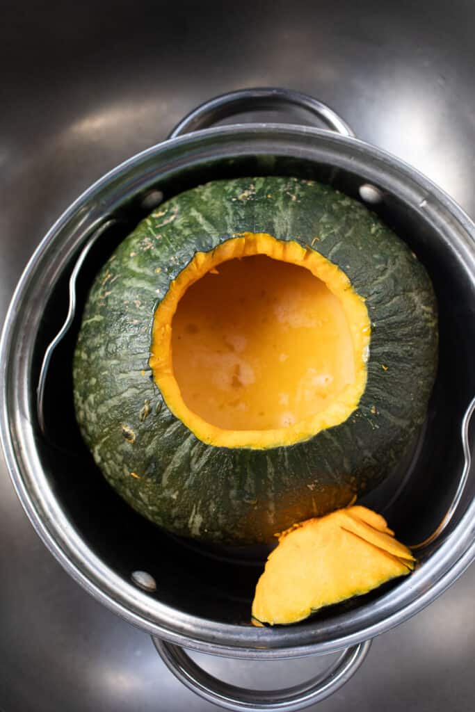 Thai steamed pumpkin custard in a steaming pot.