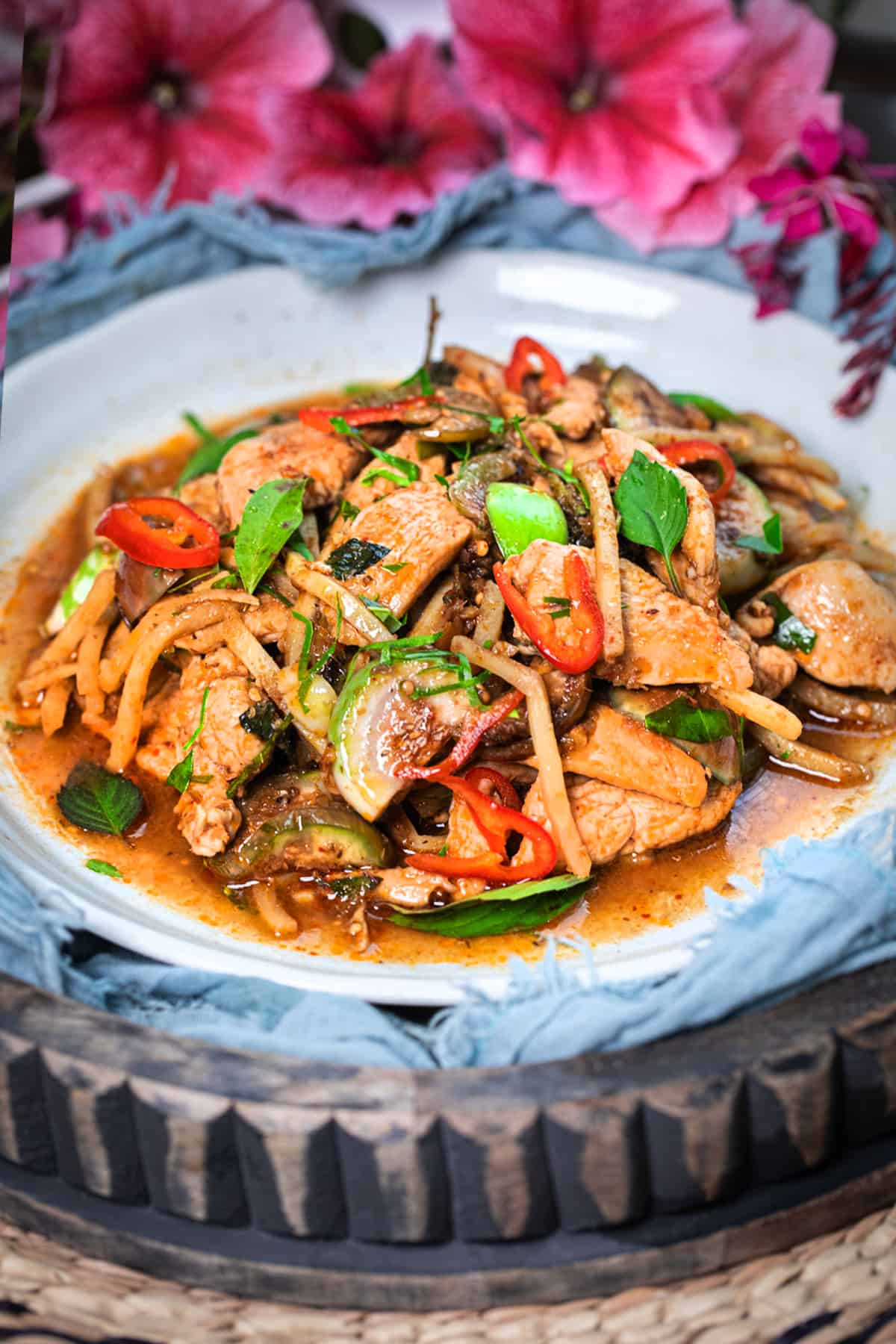 Pad Ped thai stir fry on a white plate.