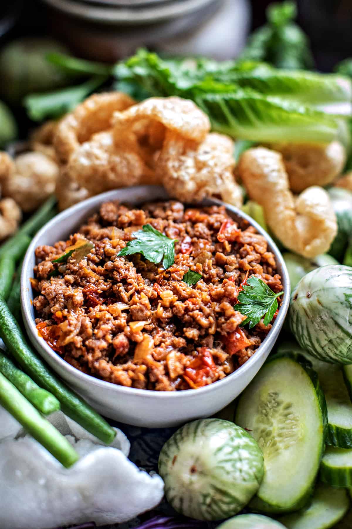 Nam Prik Ong dip in a small bowl with vegetables on a tray. 