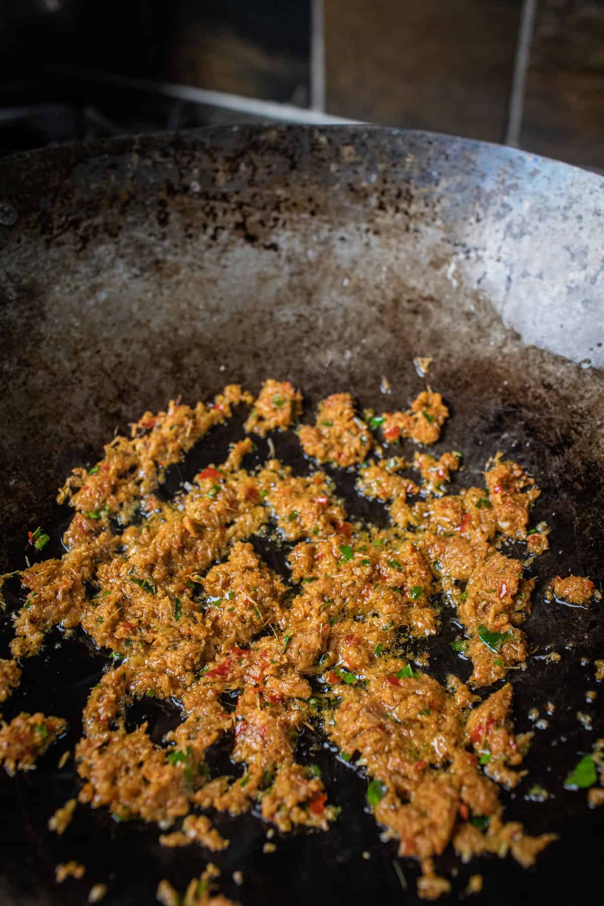 Pad Cha paste frying in a wok. 