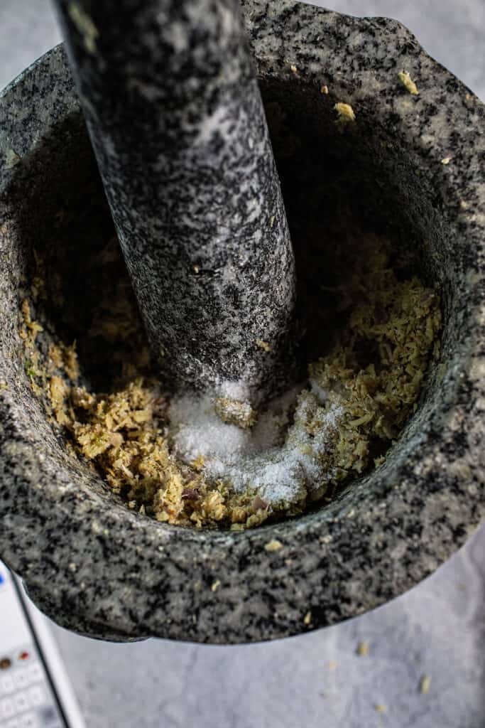 Tom kha paste ina mortar and pestle. 