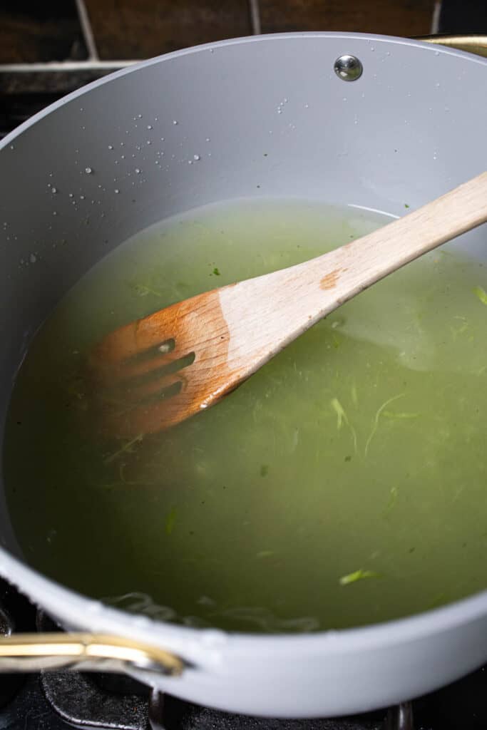 Green broth in a soup pot. 
