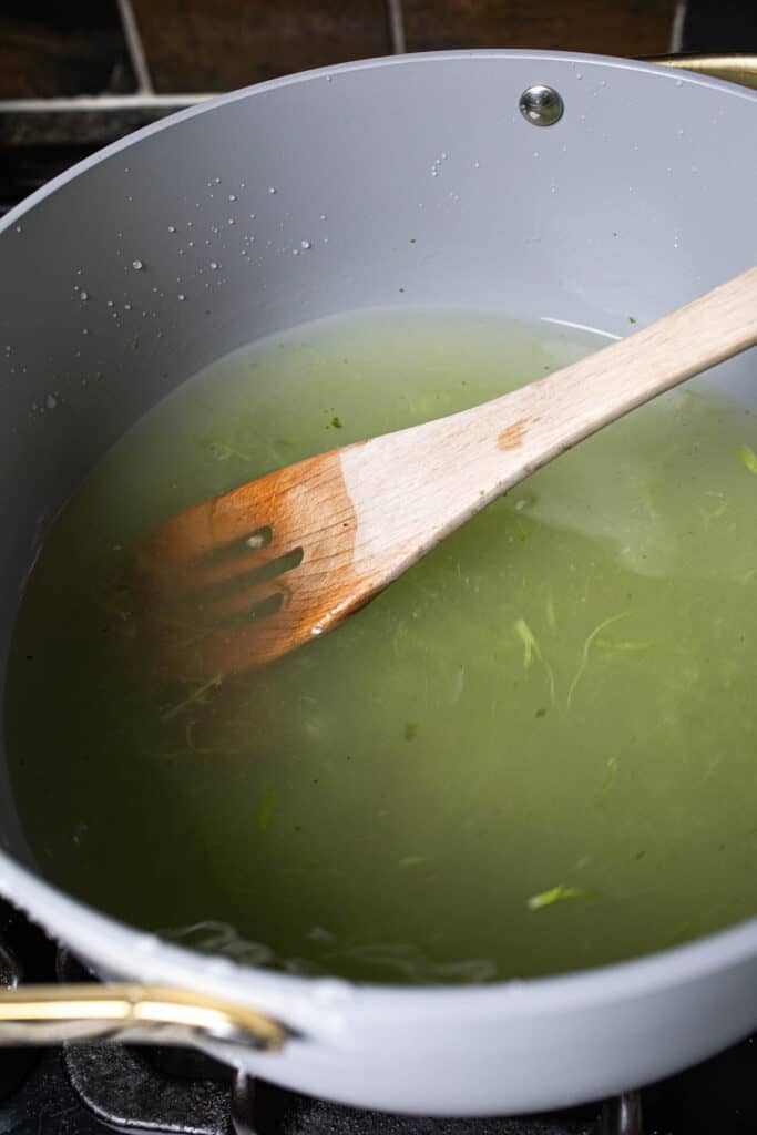 Green broth in a soup pot. 