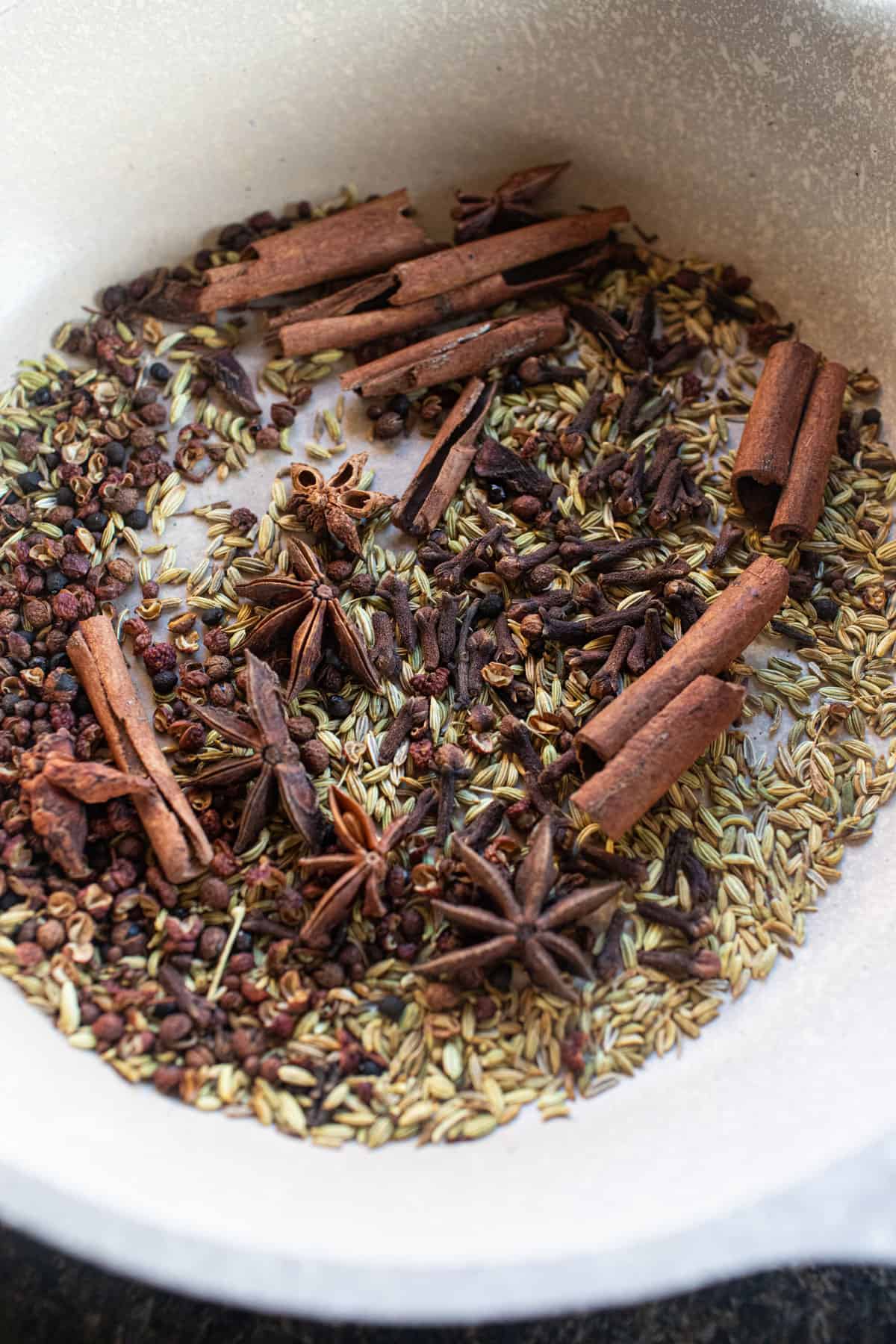 Whole spices in a pan for toasting. 