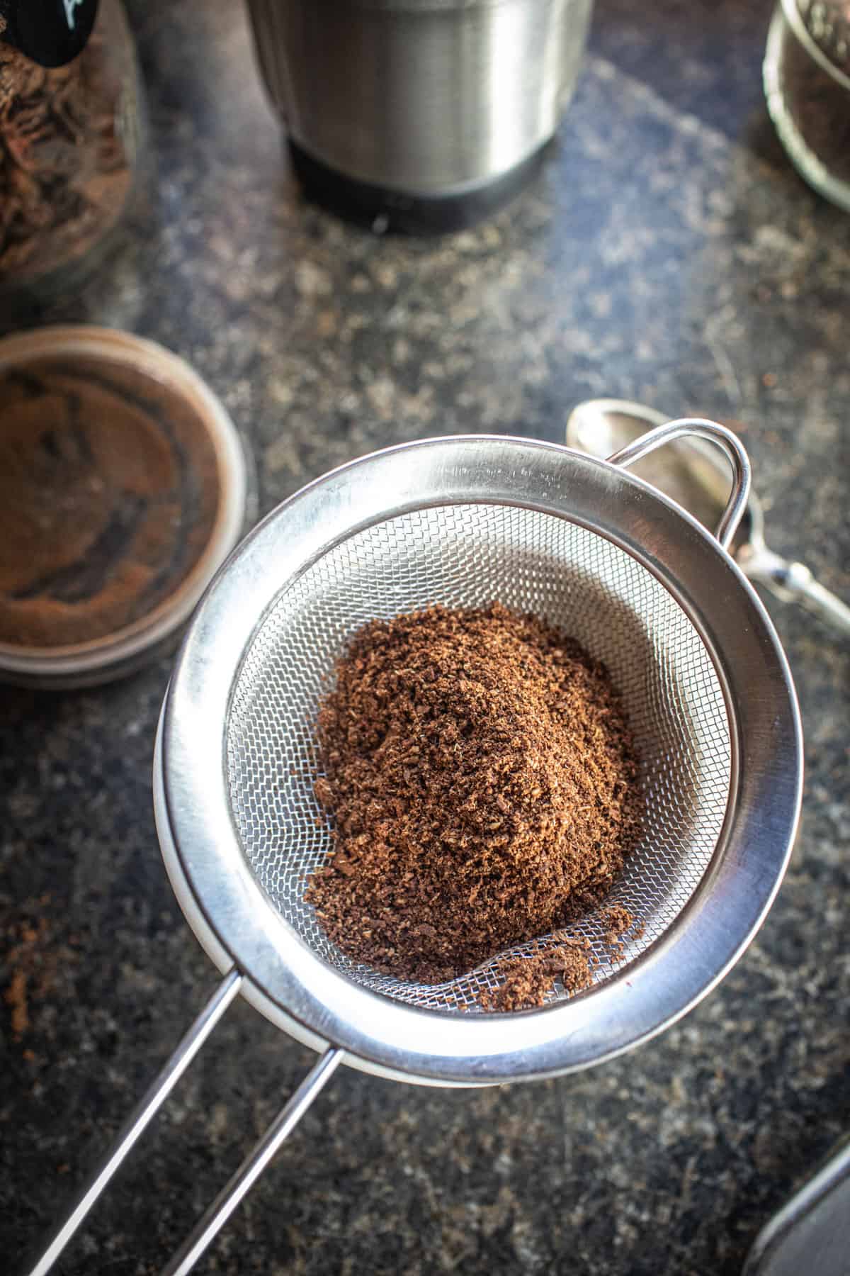 chinese Five spice powder in a fine mesh strainer.