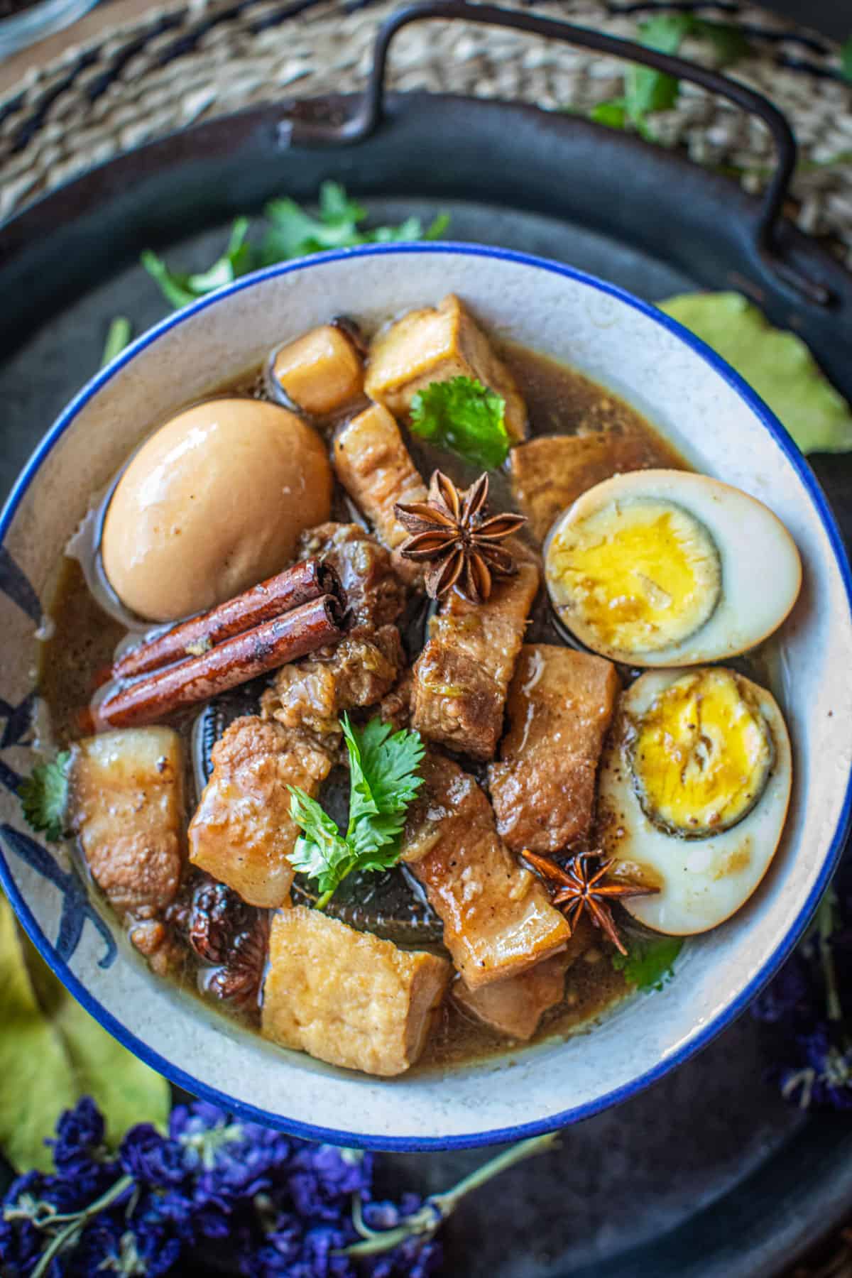 Moo Palo in a white bowl with garnishes. 