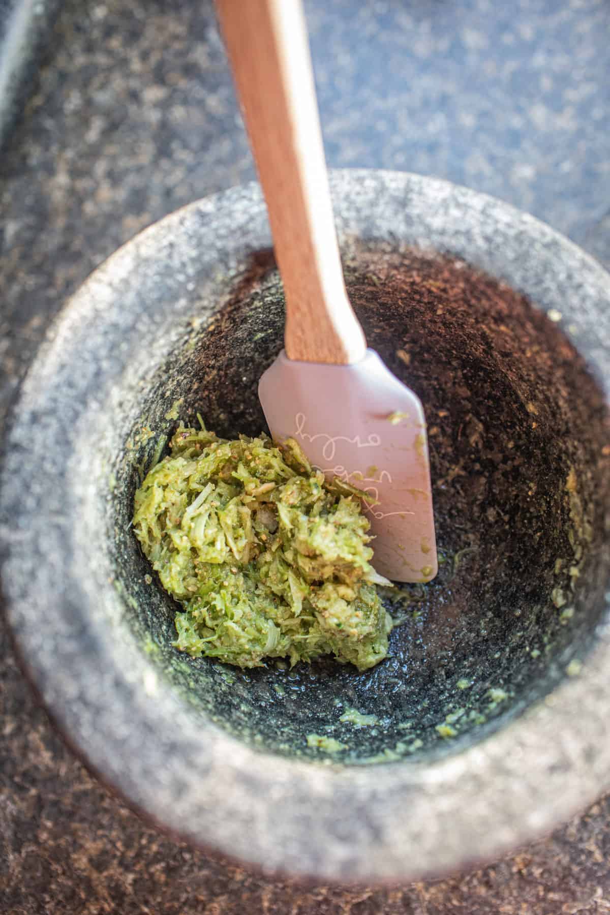 Green paste in a mortar.