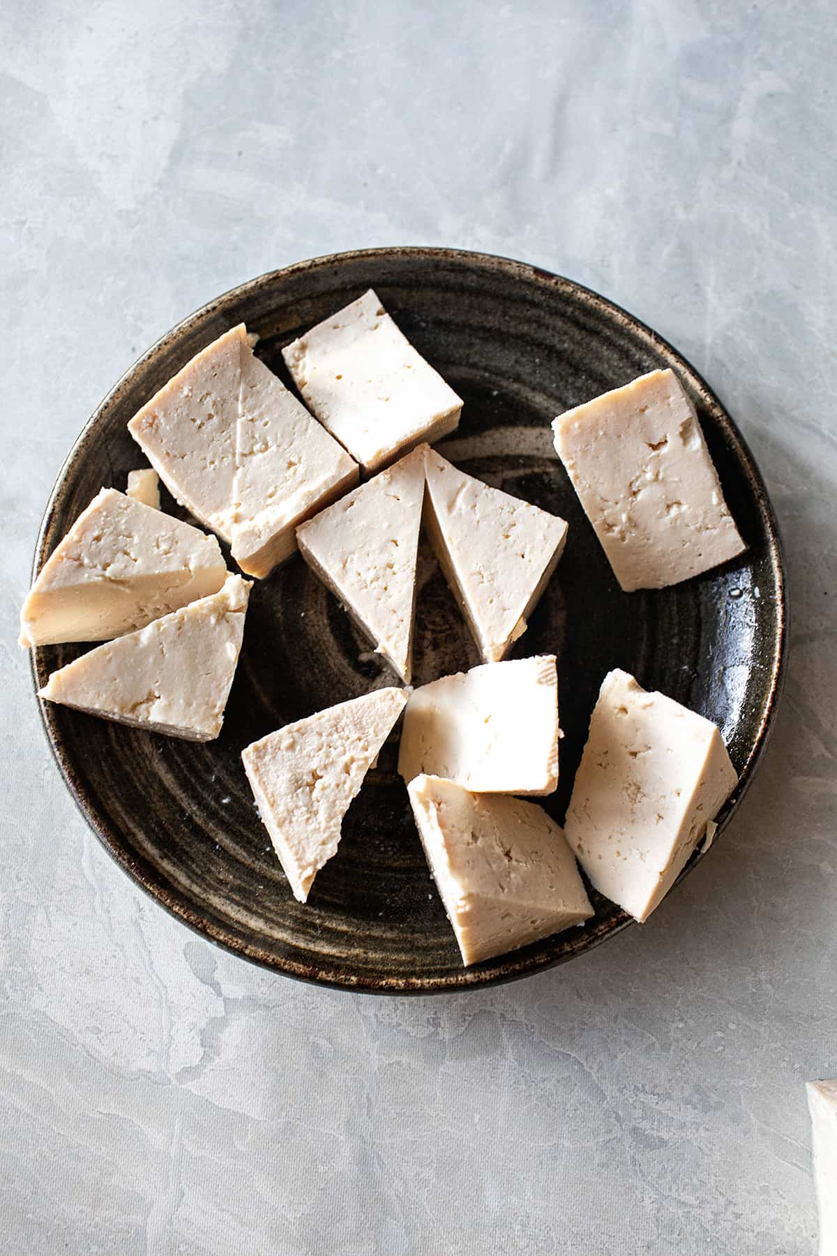 Raw tofu on a plate. 