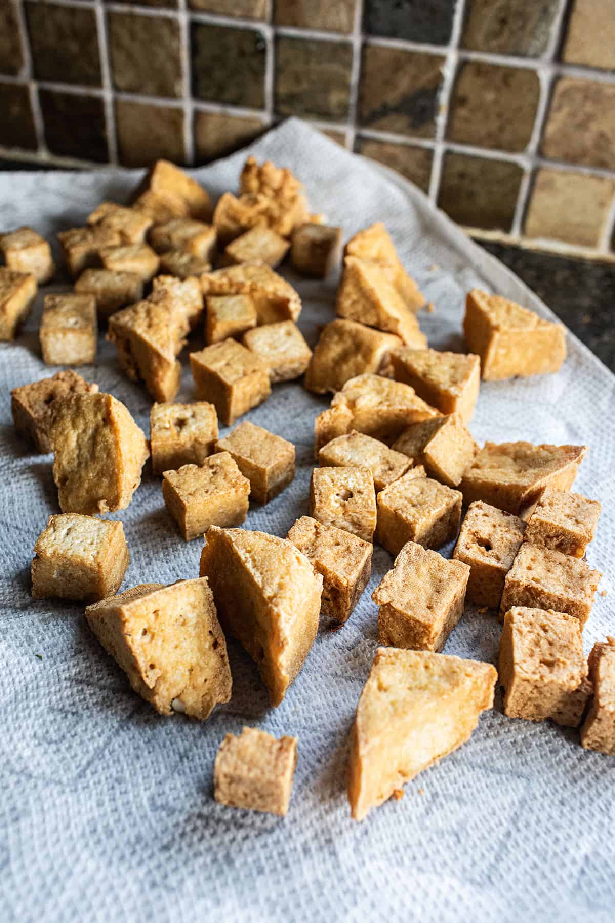 Fried puff tofu on paper towel. 