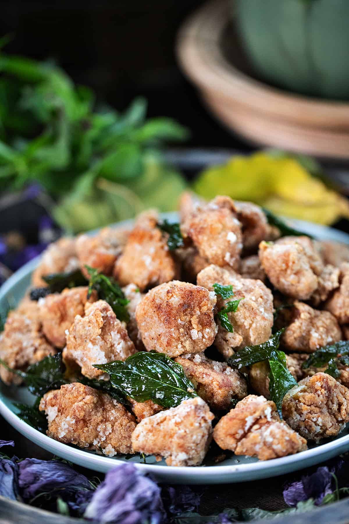 Taiwanese popcorn chicken with fried thai basil on a plate. 