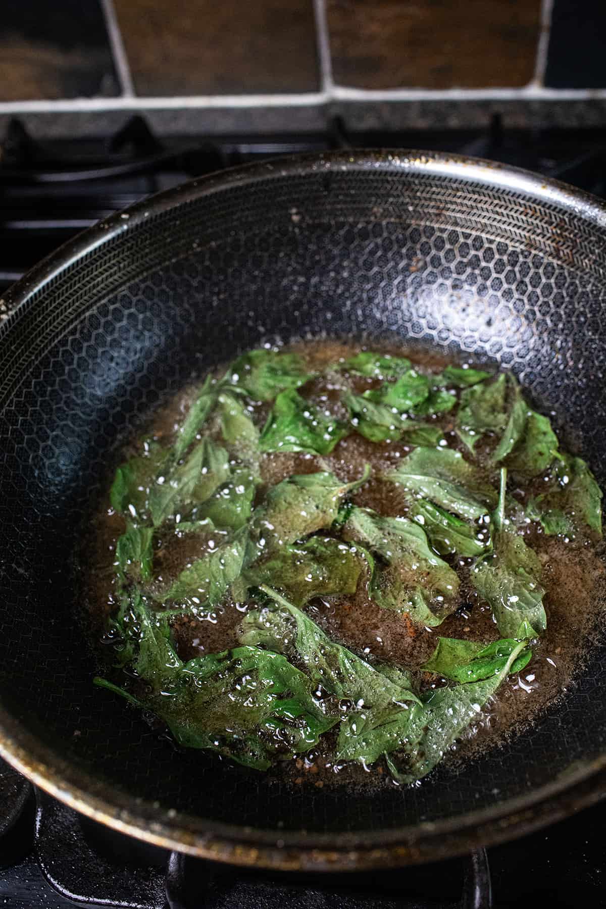 Deep fried thai basil leaves in hot oil. 