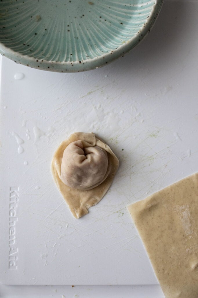 Boat shape wontons on a table. 