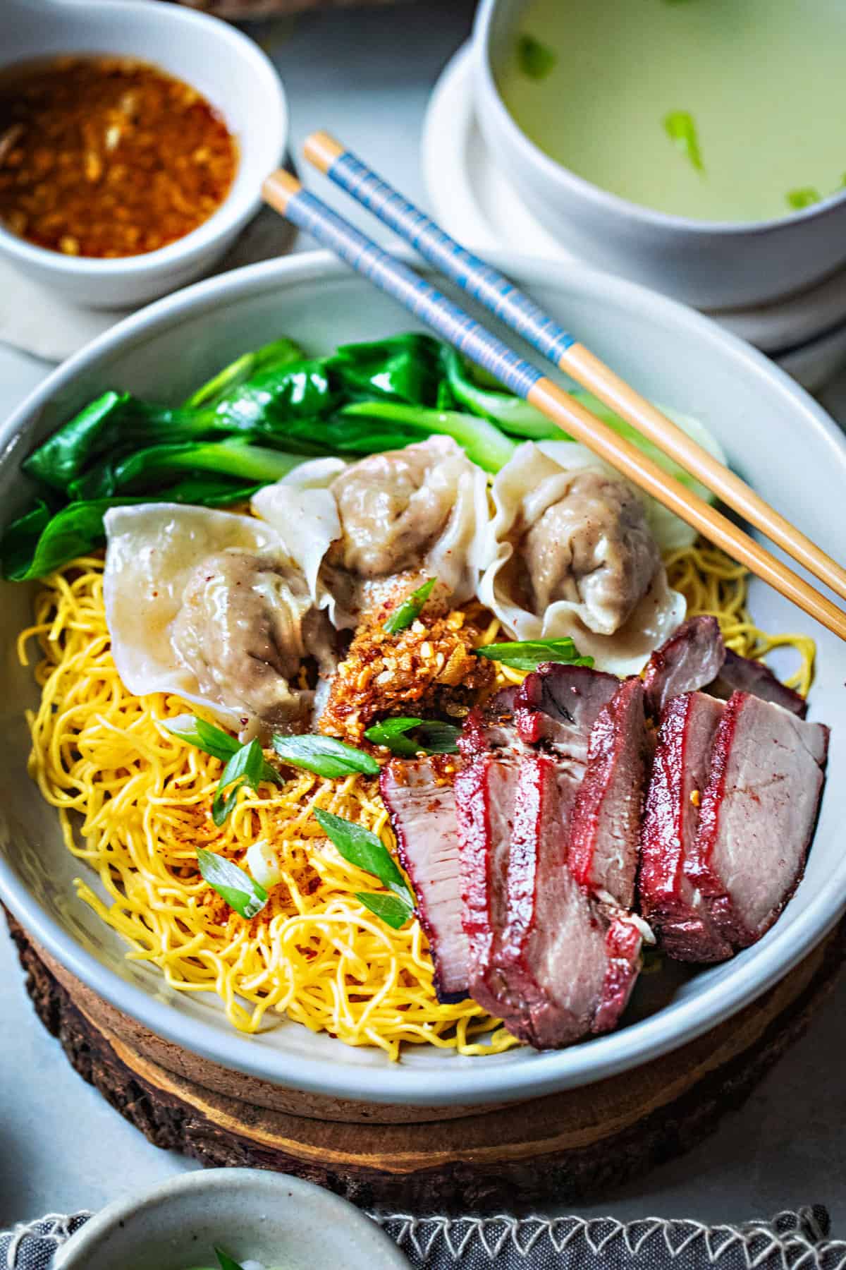 Thai noodle dish with red pork and wontons. 