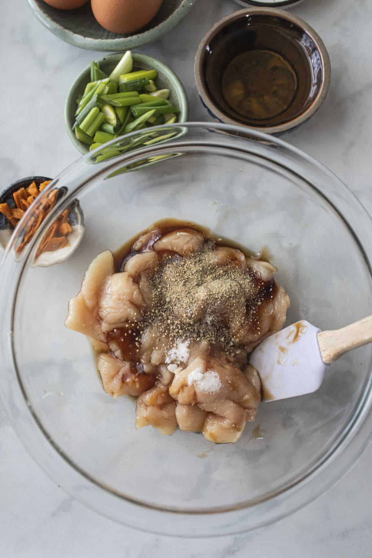 chicken and marinading sauce in a bowl. 