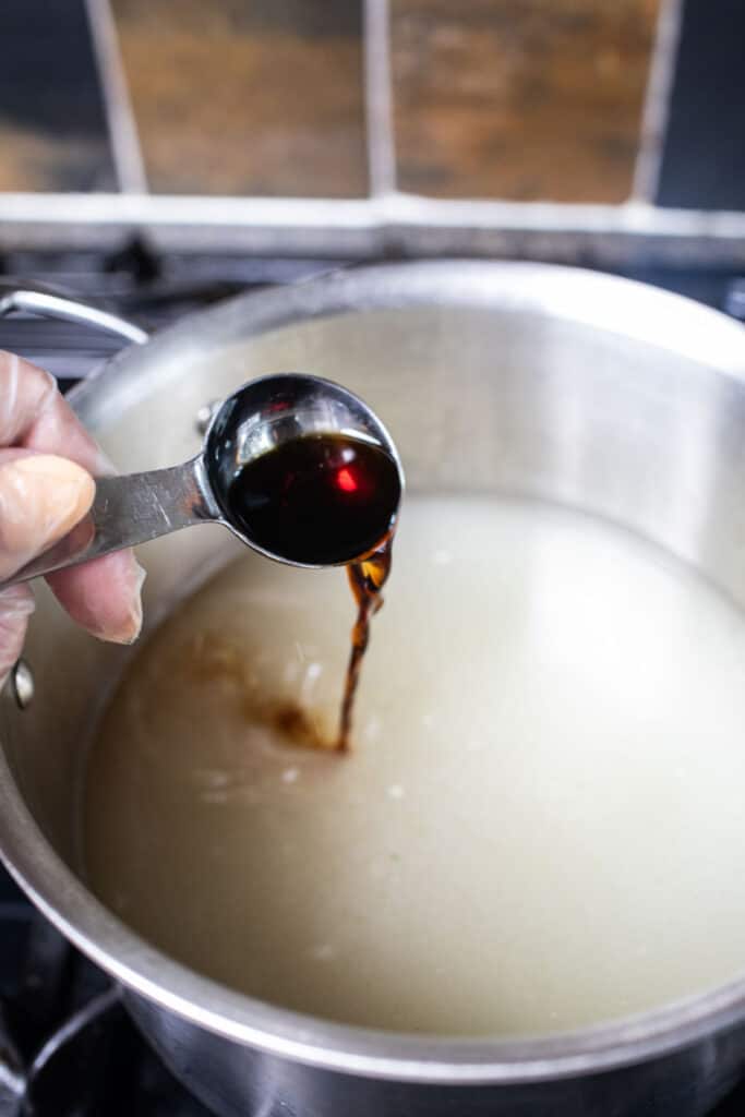 Pouring sauce into a soup pot. 