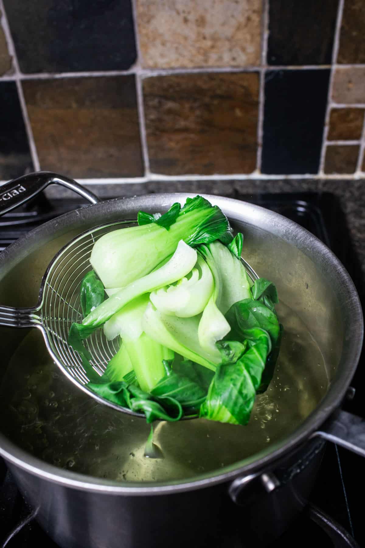 A wireless lifting bok choy  from a pot. 