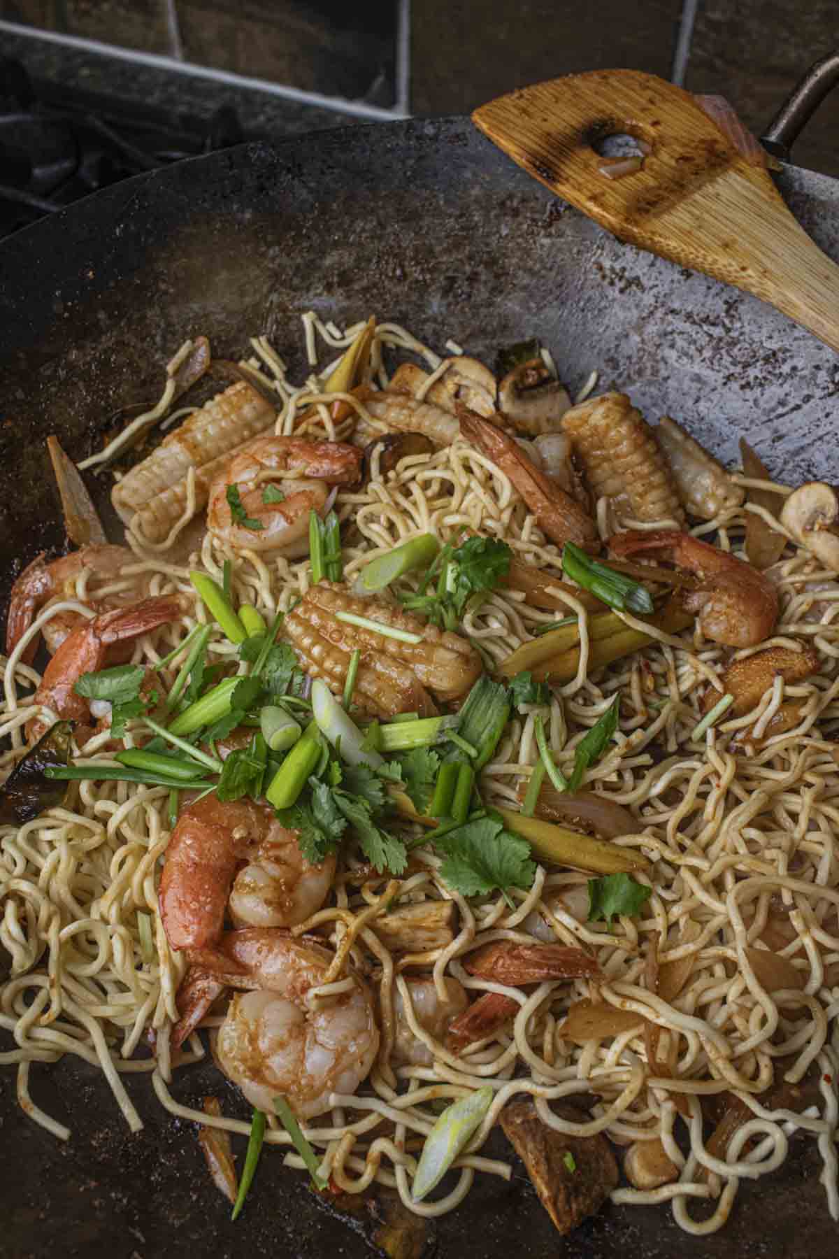 Thai Tom Yum Noodles with seafood in a wok.