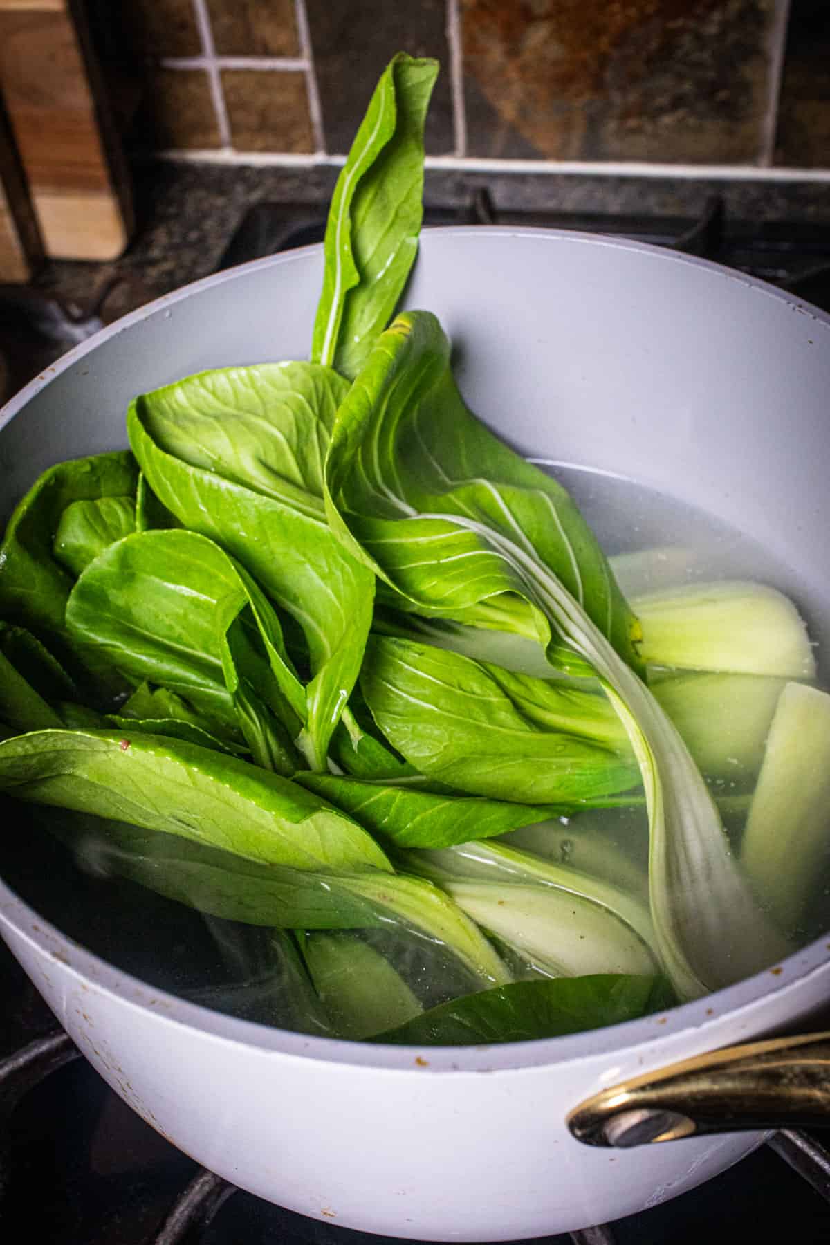 Bok chop cooking in a pot of water. 