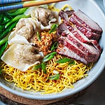 Ba mee moo dang in a bowl with pork and wontons.