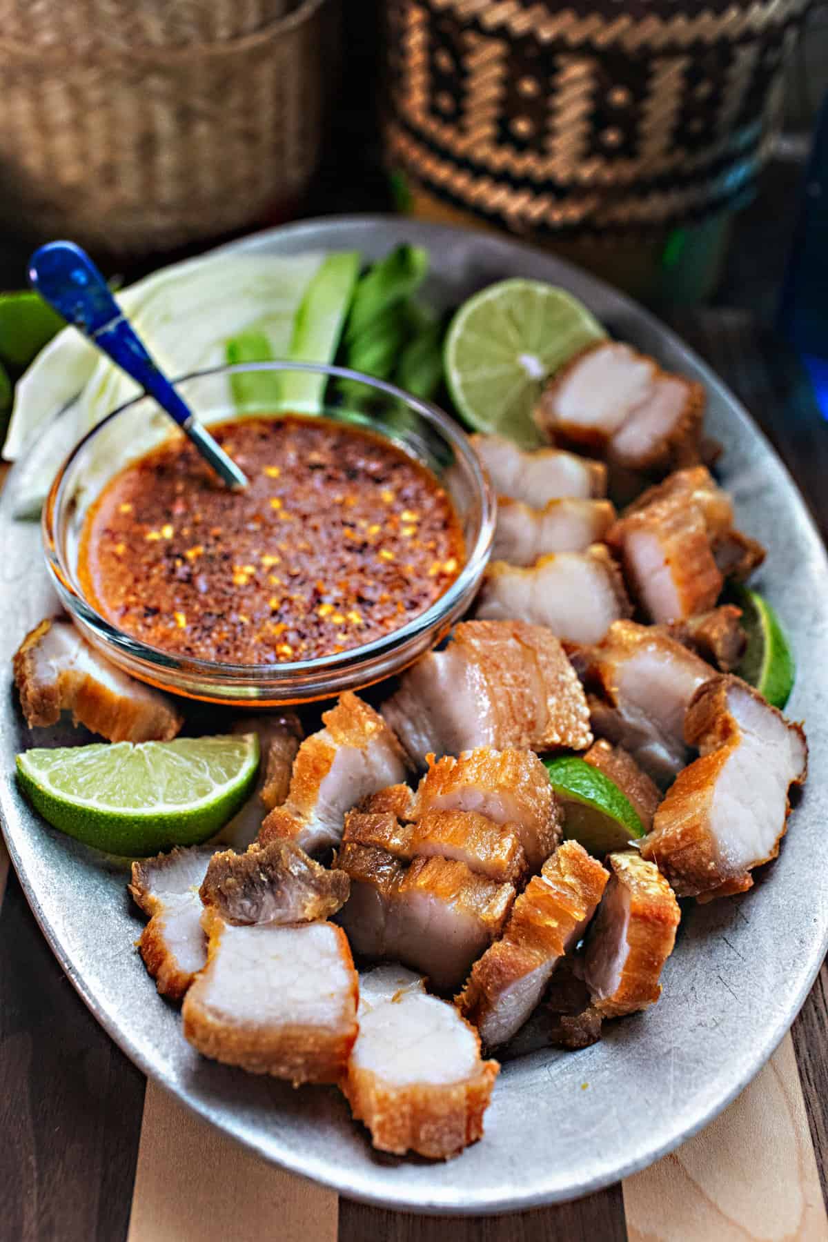 Sliced Crispy pork belly on a plate with chili dipping sauce. 