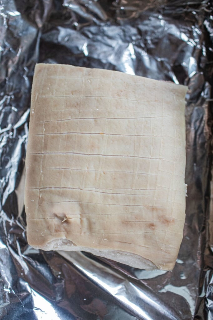 pork belly slab on a tin foil.