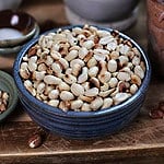 Dry roasted peanuts in a bowl on the counter.