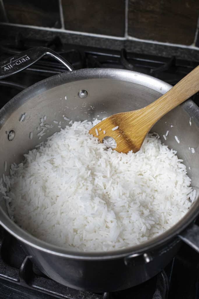 Woonden spoon in a stainless steel pot on the stove. 