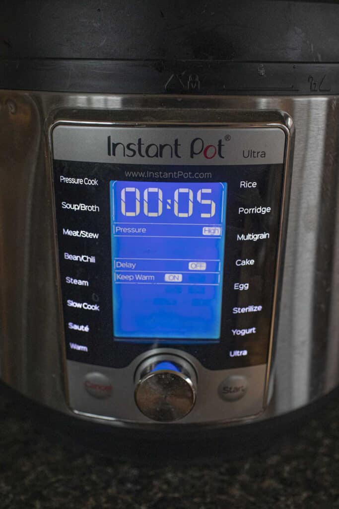 Instant pot sitting on the table at 5 minute setting. 