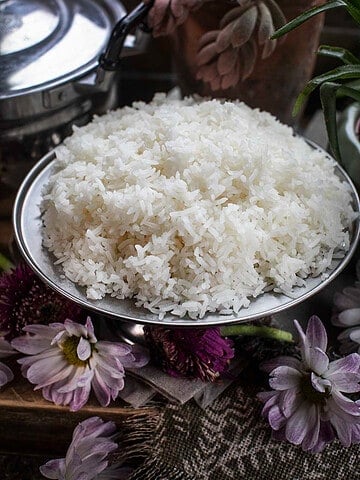 cooked jasmine rice on a silver platter on the table.