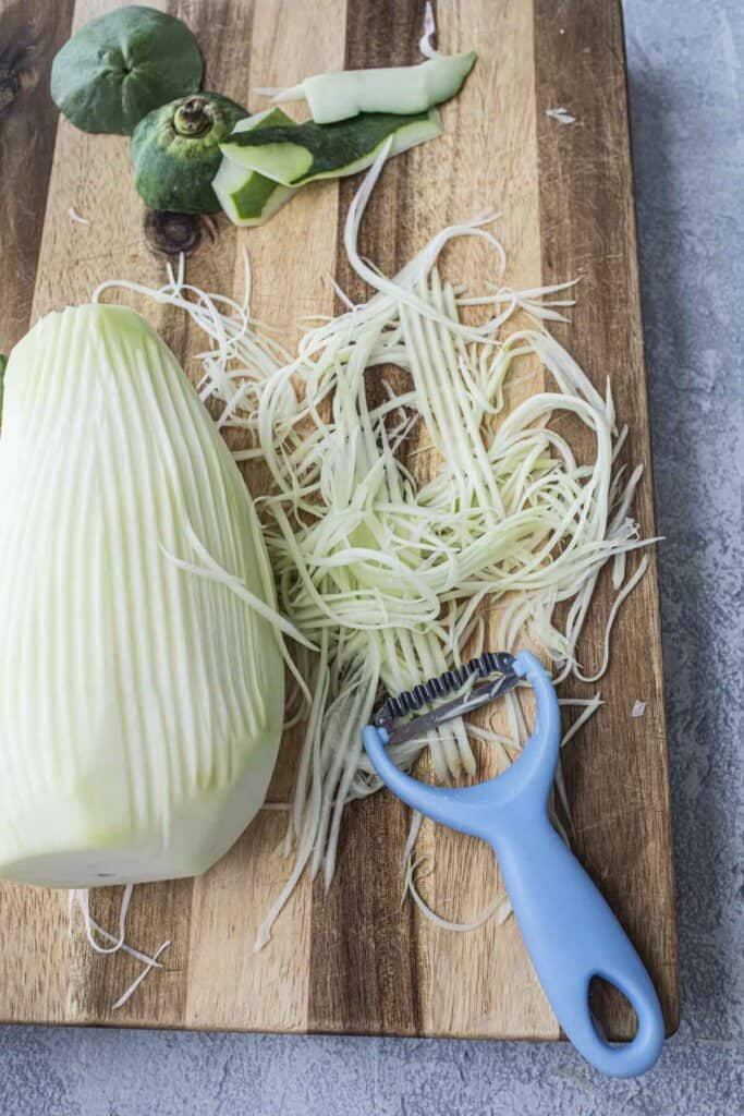 Shredded green papaya with a kiwi peeler.