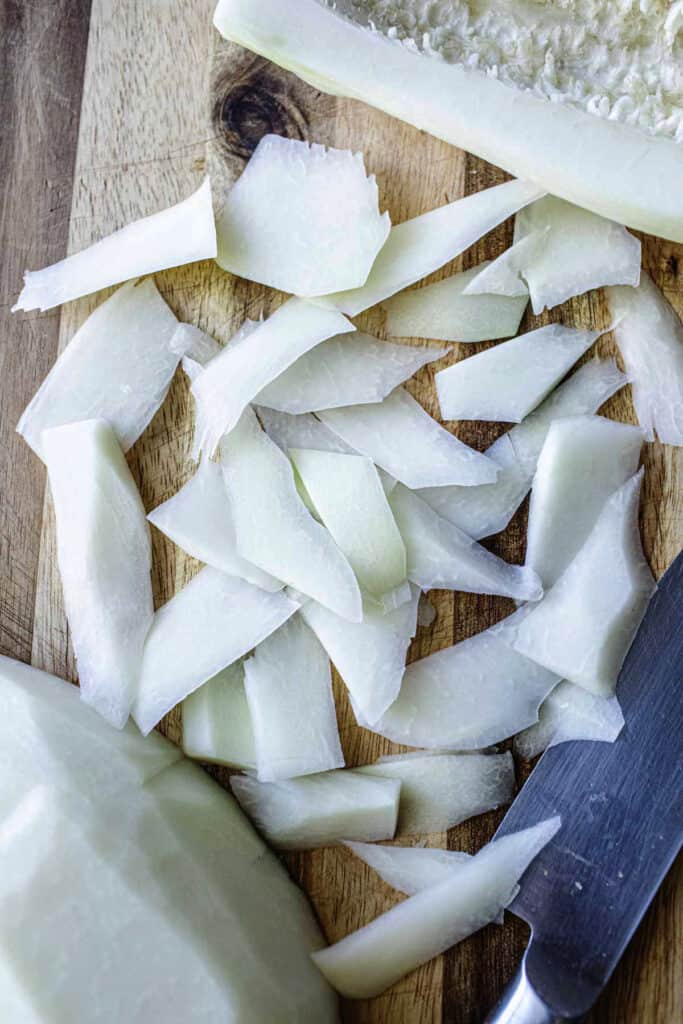 Sliced green papaya on a cutting board. 