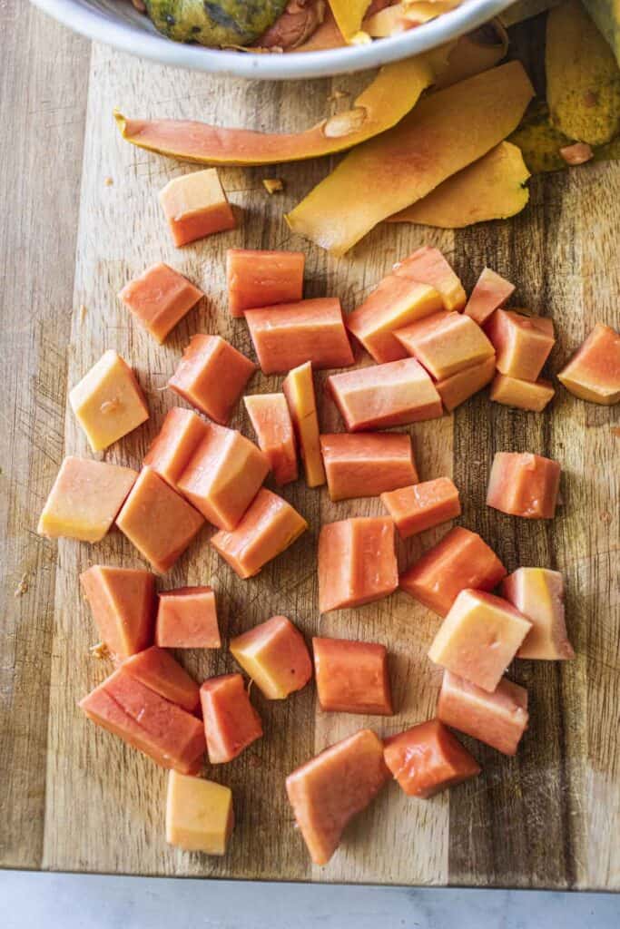 Ripe Papaya cubes on a cutting board. 