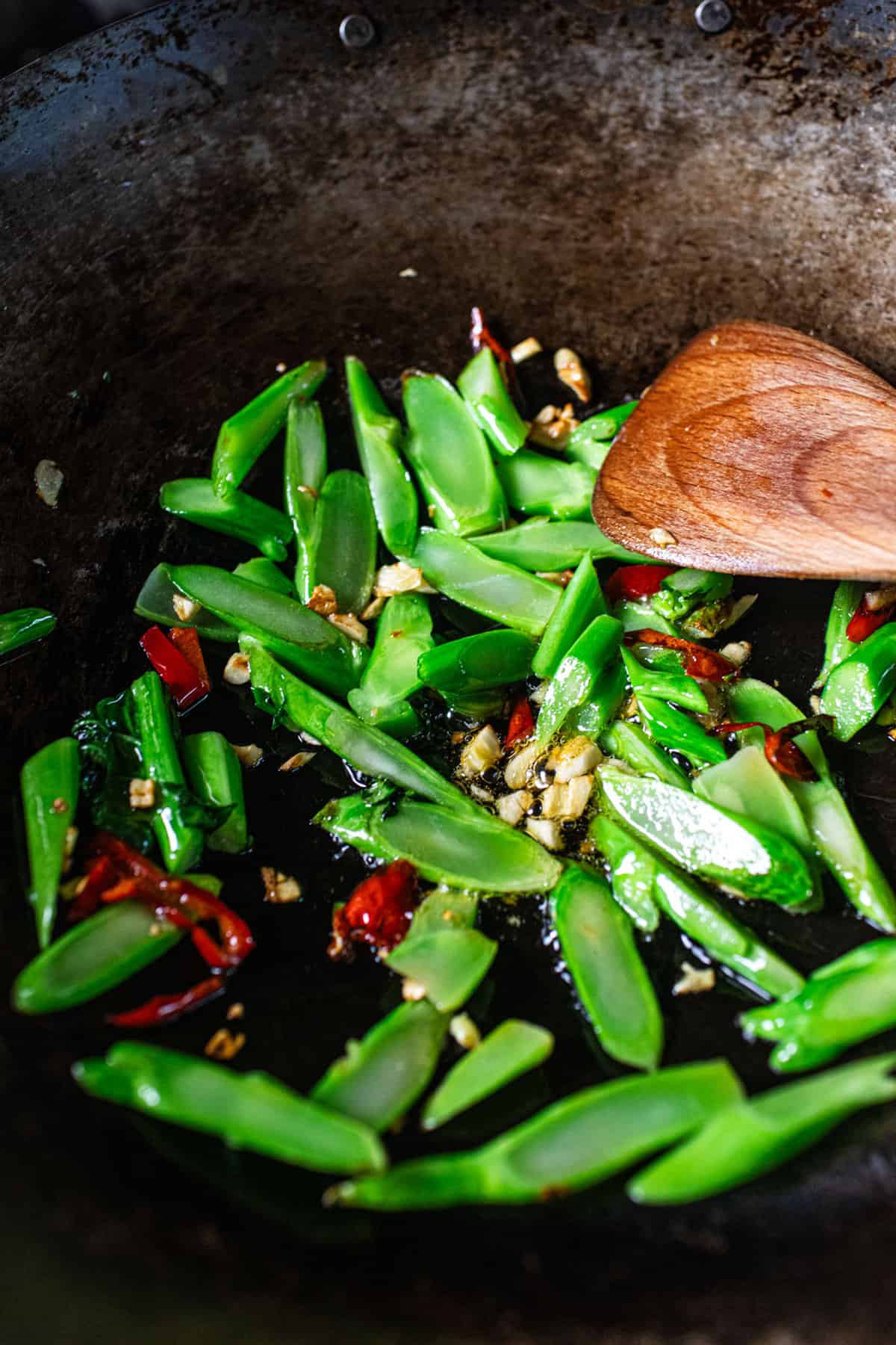 Chinese broccoli steams in a wok for Thai  pad kana recipe.