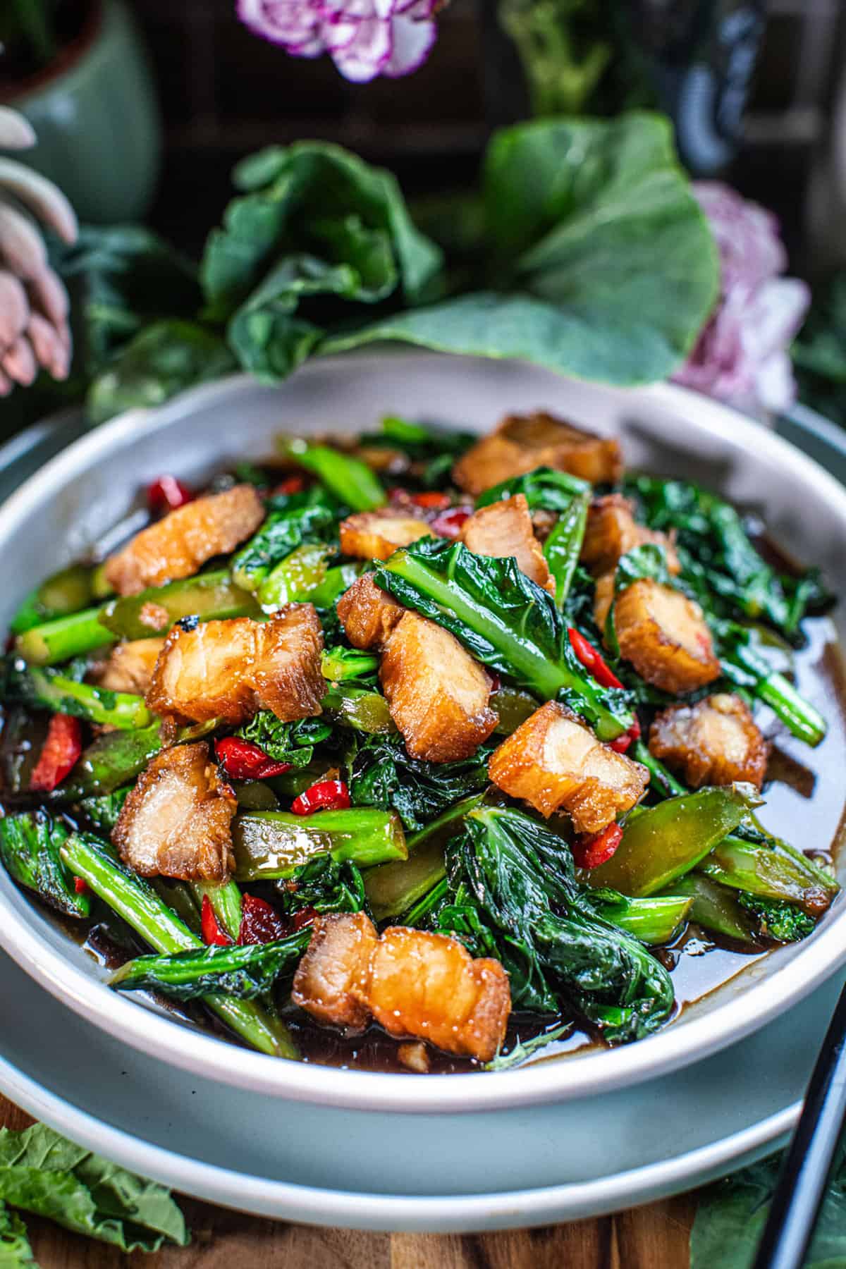 Pork belly slices and Chinese broccoli on a plate. 