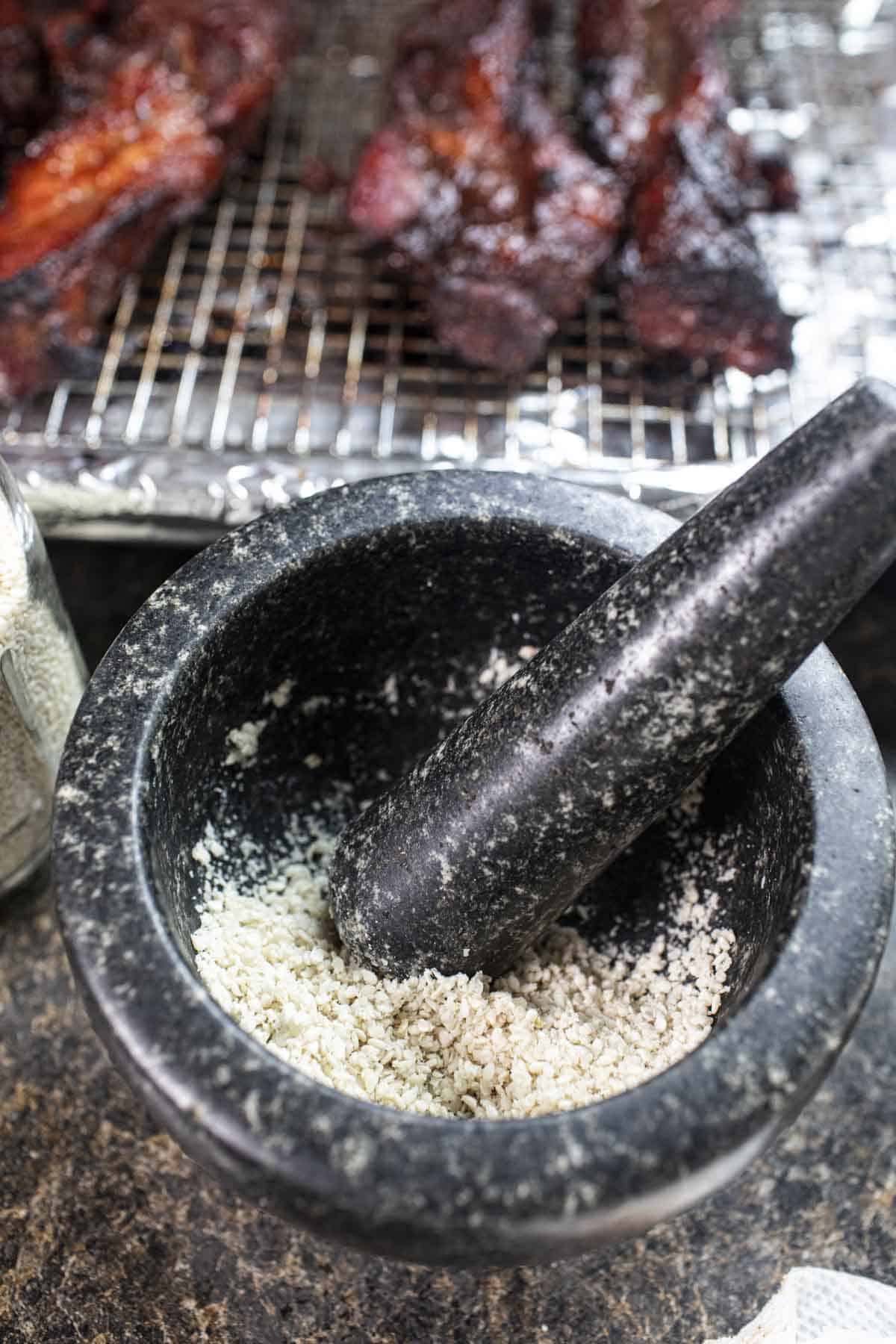 crushed sesame seeds in a mortar and pestle. 