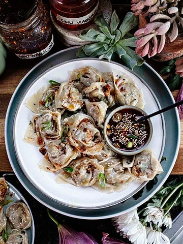 Pork and Shrimp wontons on a platter with dipping sauce.