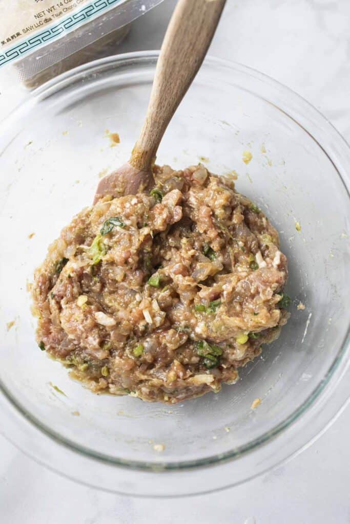 Ground meat in a bowl for wontons. 