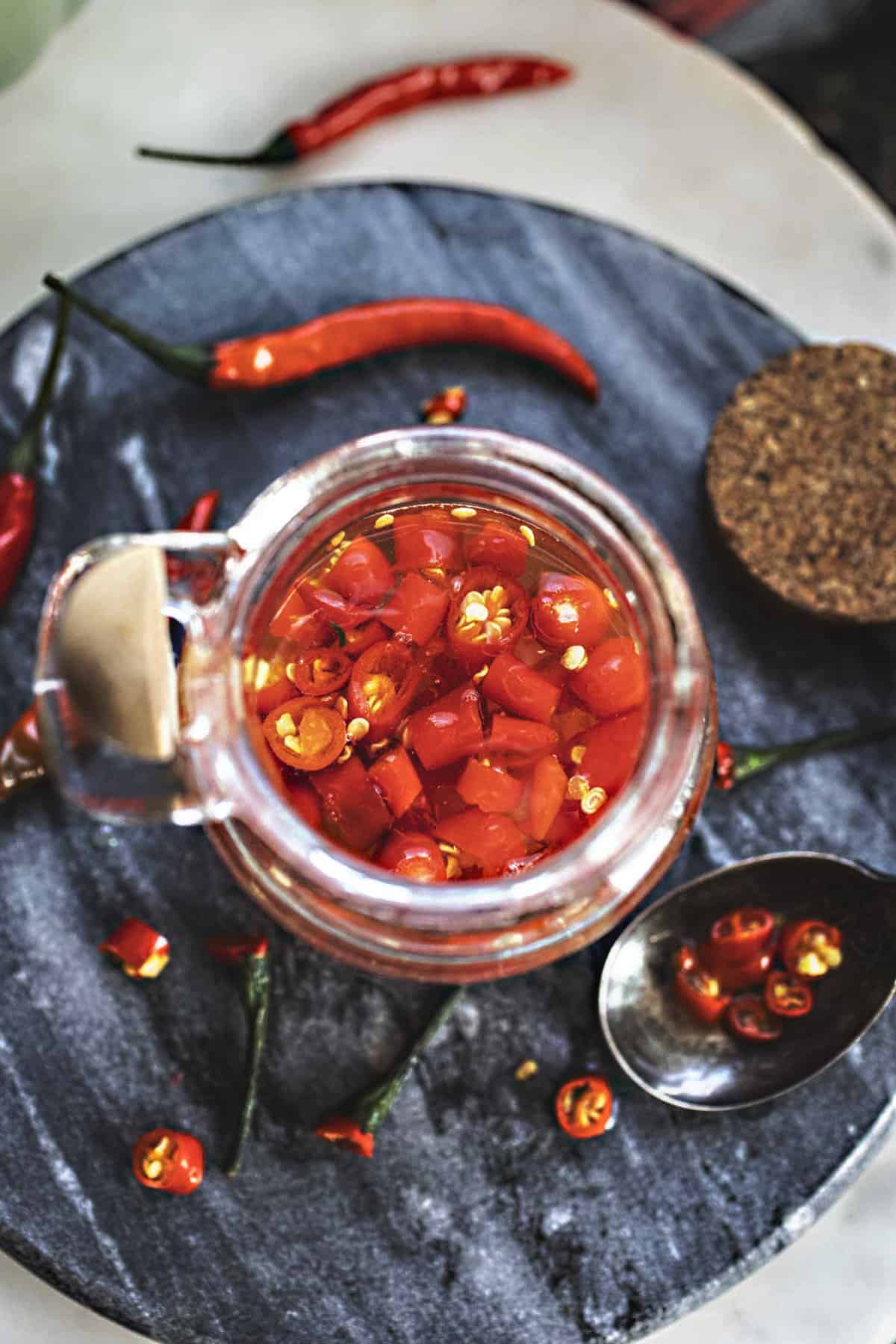 Prik Nam Som Thai Chili vinegar sauce in a glass jar. 