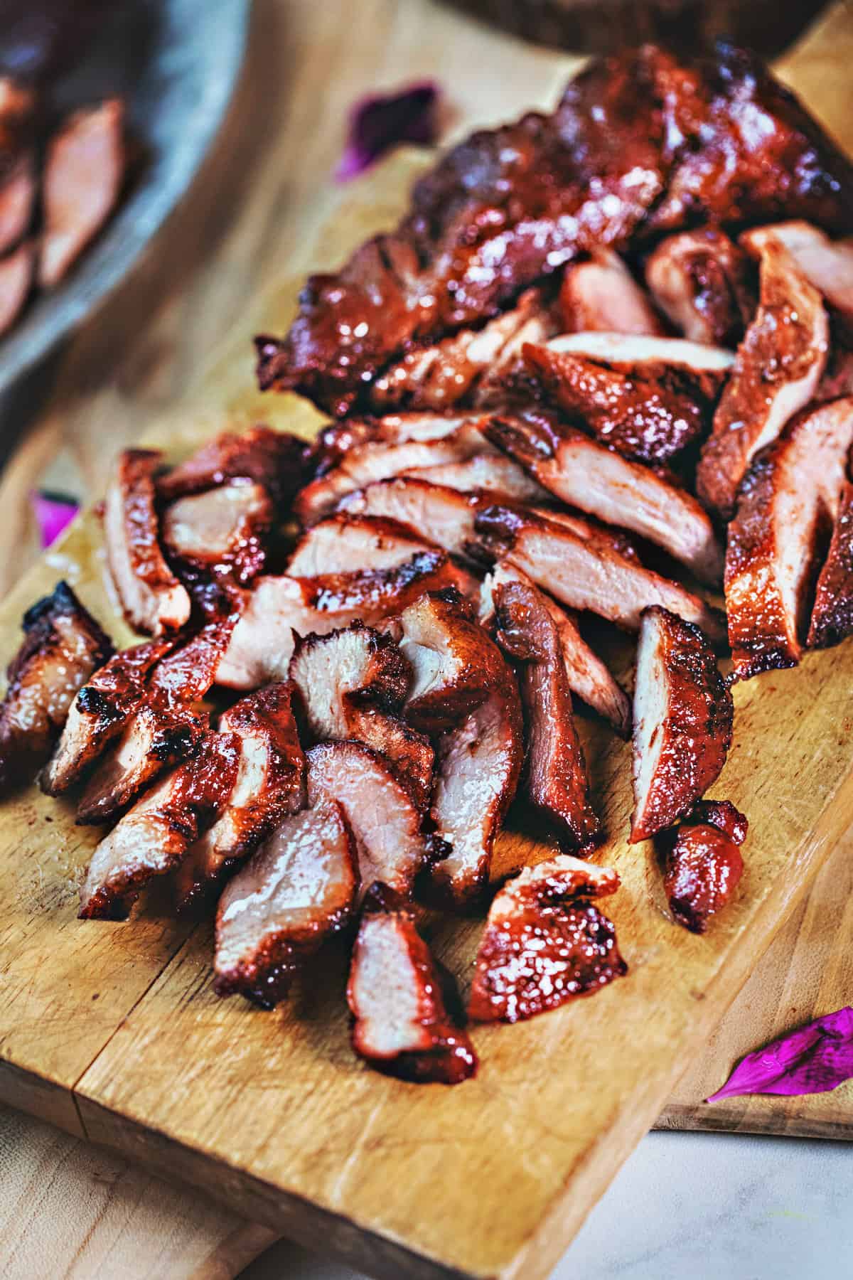 Moo Dang or red pork char siu bbq pork on a cutting board. 