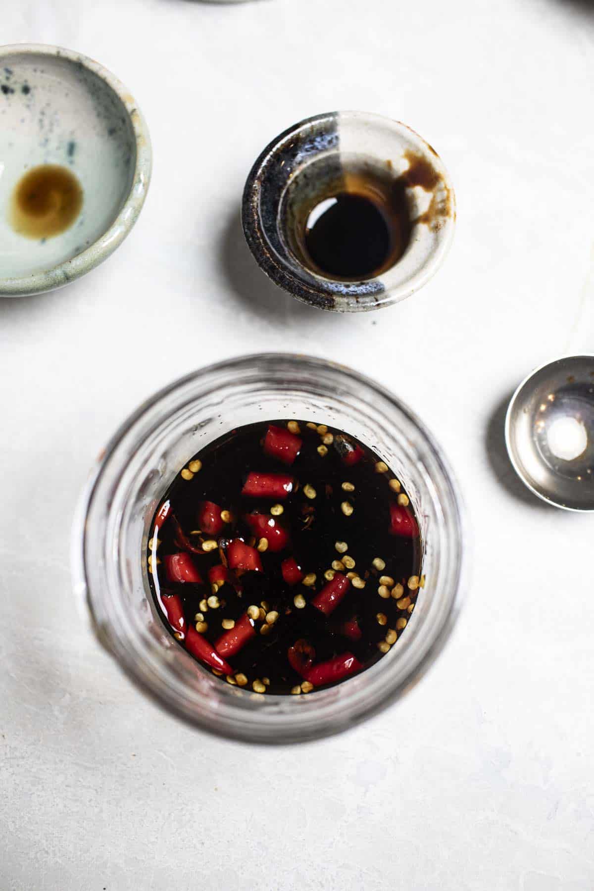 Khao moo dang spicy sauce in a Clear bowl. 