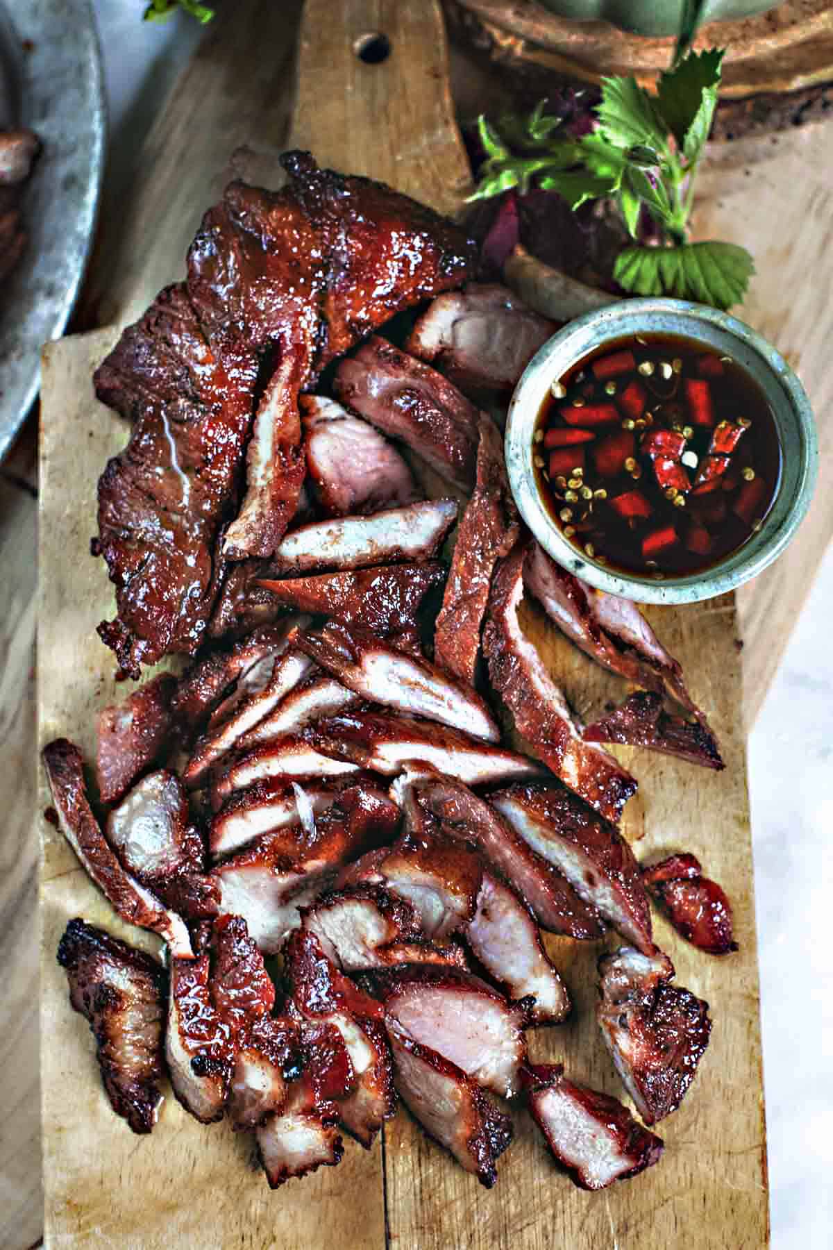 Thin slices of pork on a cutting board.