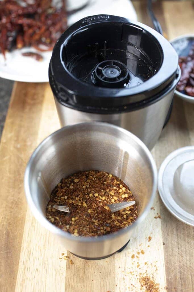 Thai pepper flakes in a spice grinder. 