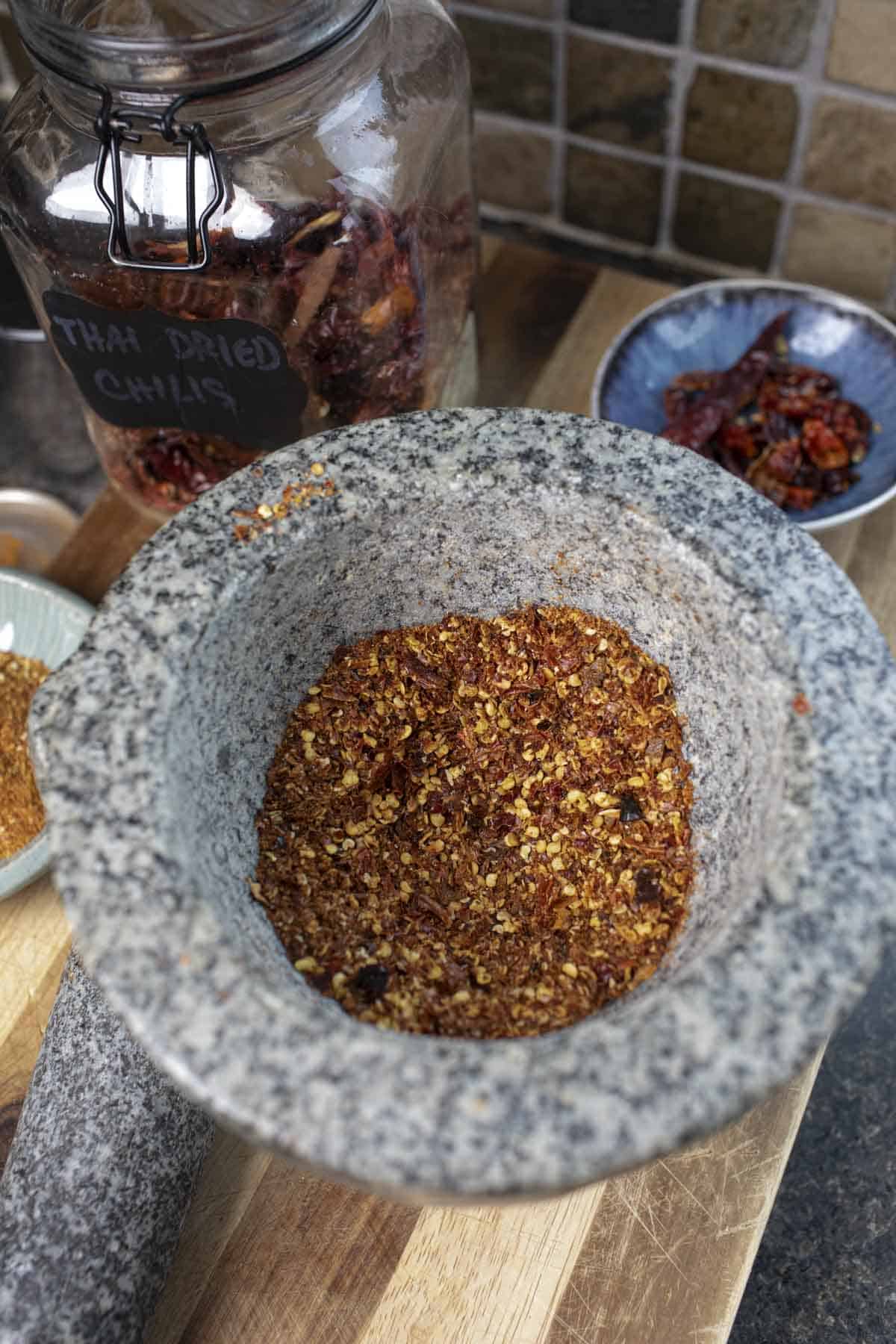 Thai pepper flakes in a mortar.