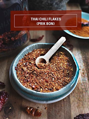 Thai chili flakes on a bowl with a small wonden spoon.