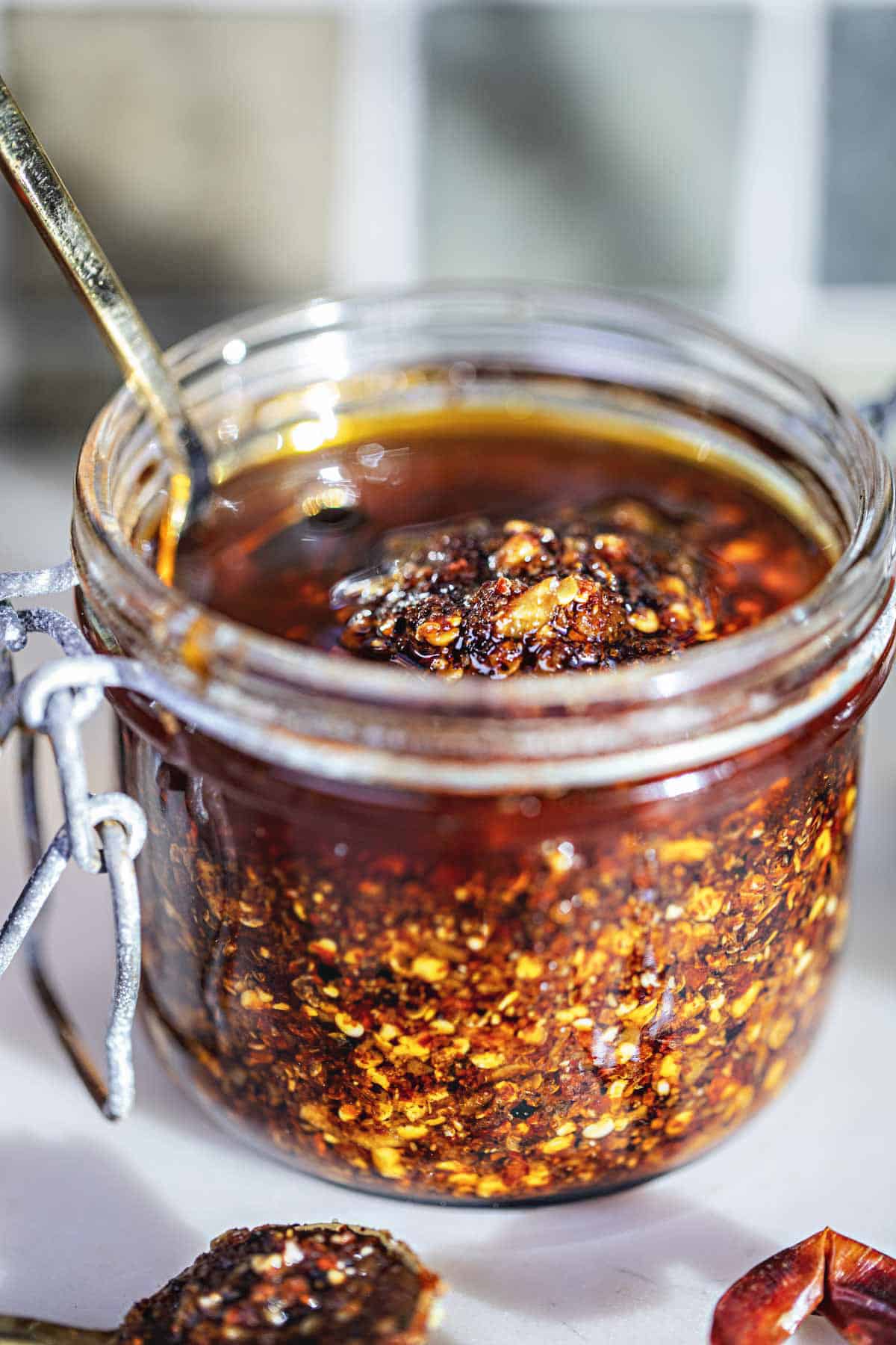 Thai Chili oil in a glass jar on the table. 