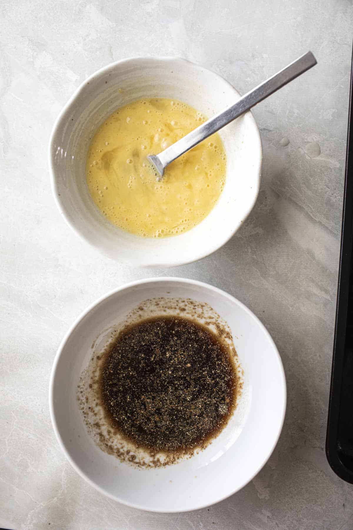 whisked eggs and sauce on in a bowl on the table. 