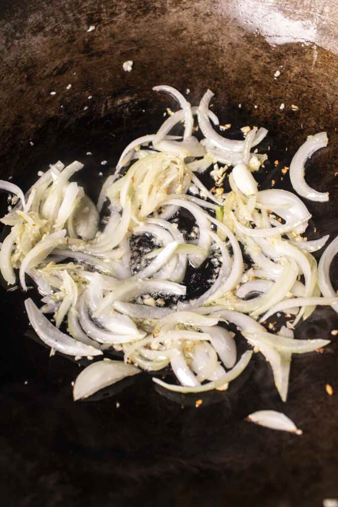 Sautéed garlic and onion in a wok. 