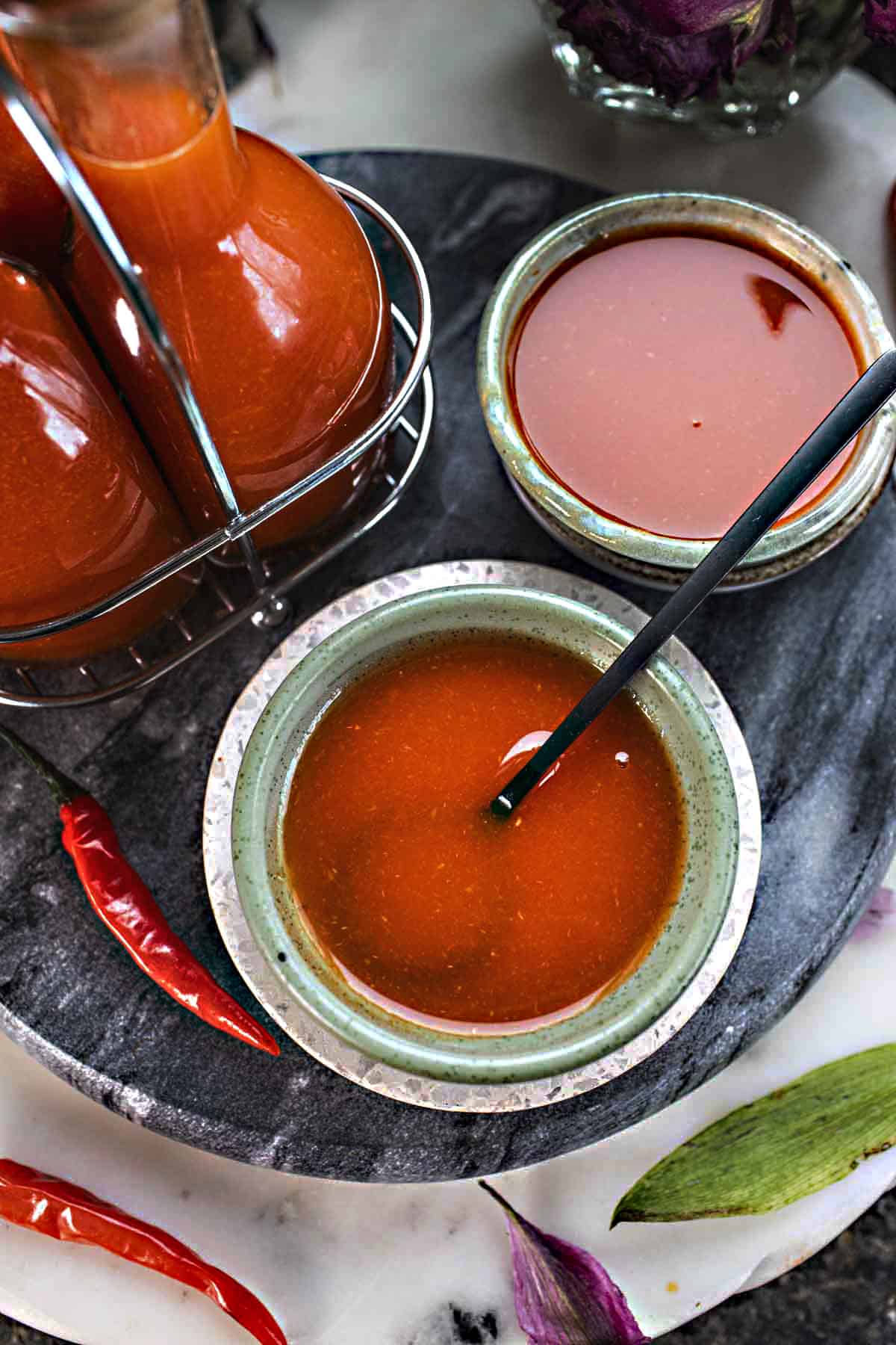 Thai hot sauce, homemade sriracha, in small bowls with a spoon in the middle. 