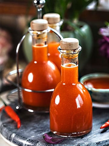 Thai hot sauce in bottles on the table.